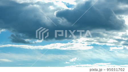Blue sky with thunderclouds. The sun breaks Blue sky with thunderclouds. The sun breaks 95031702