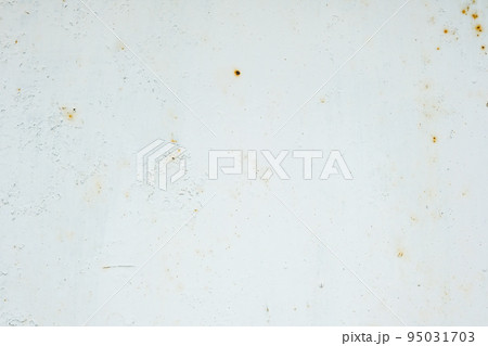 Corrosion of metal. Rust shows through the white Corrosion of metal. Rust shows through the white 95031703