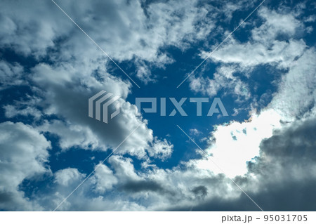 Blue sky with thunderclouds. The sun breaks Blue sky with thunderclouds. The sun breaks 95031705
