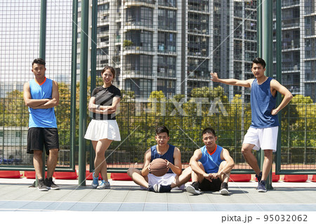 five asian young adult relaxing on an outdoor basketball court after exercising five asian young adult relaxing on an outdoor basketball court after exercising 95032062