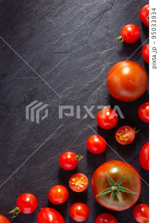 Fresh tomato on black slate background table. Tomatoes on tabletop 95033934