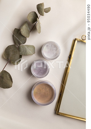 Face powder for make up in boxes on natural background with dried flowers. Aesthetics of makeup artist cosmetic beauty top view Face powder for make up in boxes on natural background with dried flowers. Aesthetics of makeup artist cosmetic beauty top view 95034490