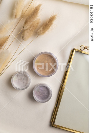 Face powder for make up in boxes on natural background with dried flowers. Aesthetics of makeup artist cosmetic beauty top view 95034491