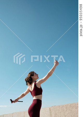 Young female taking selfie during her workout outdoors Young female taking selfie during her workout outdoors 95035498