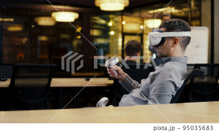 Man in VR headset in modern office 95035683