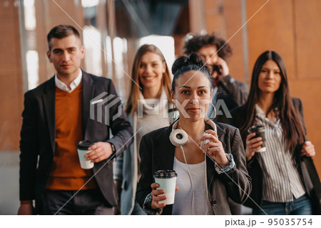 Travelers business team of colleagues walking and talking on modern urban city streets. People on out of the office on break. Travelers business team of colleagues walking and talking on modern urban city streets. People on out of the office on break. 95035754