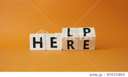 Help is here symbol. Turned wooden cubes with words Here to Help. Beautiful orange background. Business and Help is here concept. Copy space 95035864