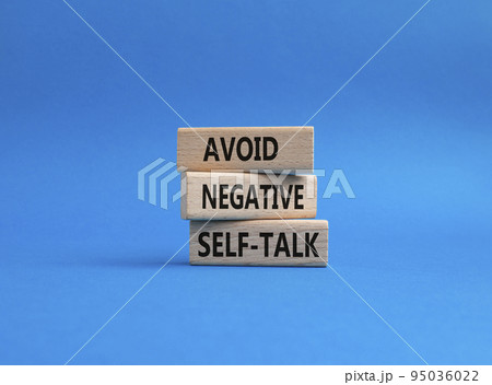 Avoid negative self-talk symbol. Concept words Avoid negative self-talk on wooden blocks. Beautiful blue background. Business and Avoid negative self-talk concept. Copy space. 95036022