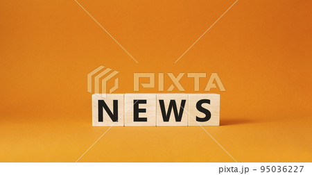 News symbol. Concept word News on wooden cubes. Beautiful orange background. Business and News concept. Copy space. 95036227