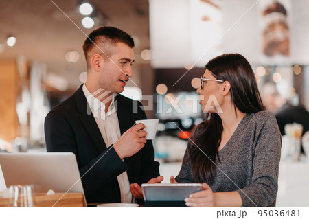 Modern man and woman use modern devices, laptop, tablet and smartphone and arrange new projects for the job. Business concept . Modern man and woman use modern devices, laptop, tablet and smartphone and arrange new projects for the job. Business concept . 95036481