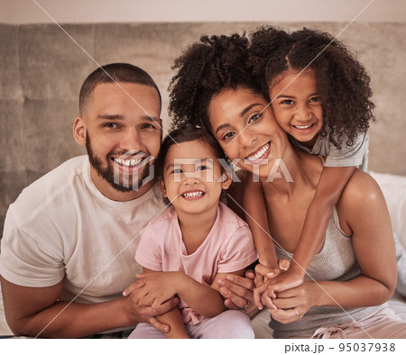Love, family and hug portrait in bedroom with Mexican parents and young kids in pyjamas. Cheerful and happy latino relatives enjoy morning cuddle together to show care and appreciation. 95037938
