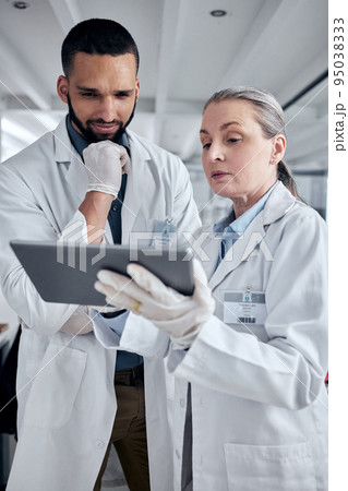 Tablet, science and research with a man and woman scientist working on the internet in their laboratory. Innovation, technology and analytics with a medicine team at work in collaboration in the lab 95038333