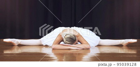 Ballet, stage and dance with woman stretching in split training and getting ready for theatre, performance or show. Creative, motivation and art with ballerina dancer in studio dancing for recital 95039128