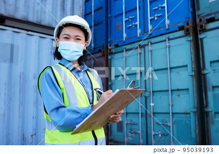 Container, covid 19 and engineer woman checklist planning cargo distribution, shipping and manufacturing logistics. Supply chain Asian manager or contractor face mask for safety and virus protection 95039193