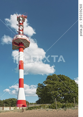control tower with radar antennas and navigation equipment on ground agains background of sky with cloud and green day control tower with radar antennas and navigation equipment on ground agains background of sky with cloud and green day 95039260