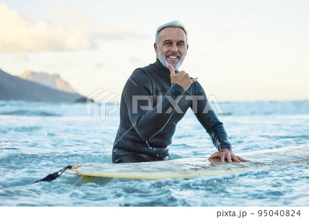 Senior man surfing in Hawaii beach, surf culture hands signal and healthy fitness in ocean nature. Friendly surfer easy greeting, retirement travel of elderly person and sea adventure lifestyle Senior man surfing in Hawaii beach, surf culture hands signal and healthy fitness in ocean nature. Friendly surfer easy greeting, retirement travel of elderly person and sea adventure lifestyle 95040824