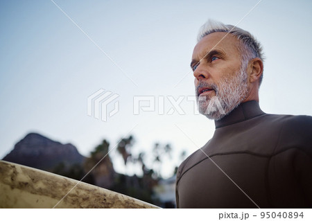 Summer, travel and surfing with senior man at beach on Hawaii vacation for sports, nature and fitness. Wellness, health and training with surfer on holiday for peace, calm and exercise in the morning Summer, travel and surfing with senior man at beach on Hawaii vacation for sports, nature and fitness. Wellness, health and training with surfer on holiday for peace, calm and exercise in the morning 95040894