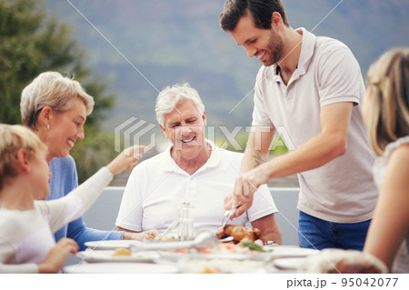 Family eating lunch outdoor garden for holiday celebration, fathers day or thanksgiving turkey food. Happy, care and love people with grandparents and child brunch together in garden to celebrate dad Family eating lunch outdoor garden for holiday celebration, fathers day or thanksgiving turkey food. Happy, care and love people with grandparents and child brunch together in garden to celebrate dad 95042077