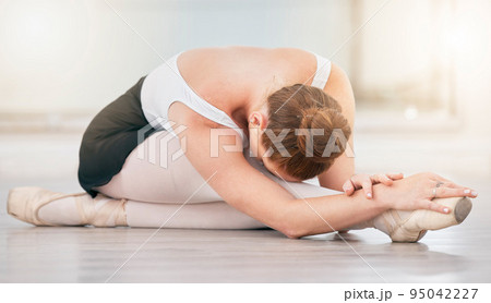 Ballet training, stretching legs and dancing performance in studio on floor. Ballerina artist, dancer and woman with balance, flexible body and creative skill learning concert production for theatre 95042227