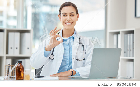 Ok hand sign, women doctor or laptop in hospital for medical, healthcare insurance or surgery approval. Portrait of smile, happy or motivation medicine employee with okay gesture for success research 95042964