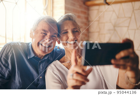 Old couple, phone and selfie smile in restaurant spending quality time together. Romance, love and retired man, woman and picture on 5g mobile, happy memory or social media post to celebrate marriage 95044136