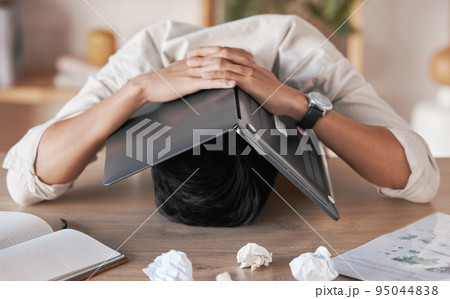 Stress, frustrated and burnout for man with laptop to cover face, head or skull overwhelmed with paperwork. Marketing business man with crumble paper and frustration from work load, chaos or problem Stress, frustrated and burnout for man with laptop to cover face, head or skull overwhelmed with paperwork. Marketing business man with crumble paper and frustration from work load, chaos or problem 95044838