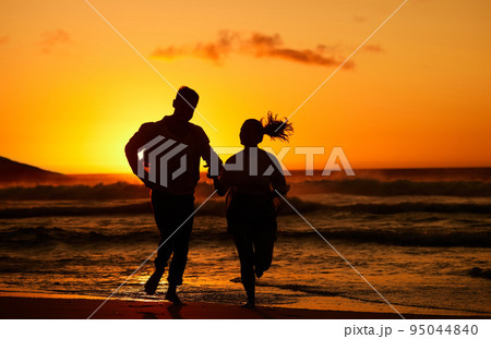 Fitness, beach and couple silhouette running at sunset, training in water and health workout. Love, sunrise and woman and man bond while exercise along the sea, healthy lifestyle with morning cardio Fitness, beach and couple silhouette running at sunset, training in water and health workout. Love, sunrise and woman and man bond while exercise along the sea, healthy lifestyle with morning cardio 95044840