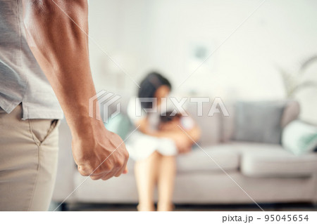 Angry, frustrated and domestic violence man fist or hand with wife in the house. Husband in a toxic relationship, marriage or anger problem with control issue with child abuse, woman or wife 95045654