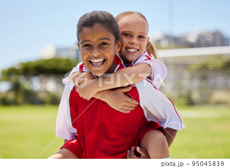 Portrait, friends and soccer player bonding at a field, having fun after sports game outdoors. Diversity, children and fitness hobby by girls embracing and laughing, playful and positive energy 95045839