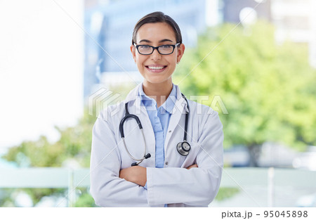 Healthcare, proud and doctor woman portrait with stethoscope in a hospital with bokeh and lens flare. Care, trust and mission of a young medical professional expert or worker with wellness motivation 95045898