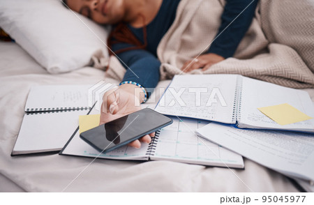 Phone, books and sleeping woman student tired from learning, studying and education exam paper in bed. University or college girl rest with mobile smartphone for online research paperwork document Phone, books and sleeping woman student tired from learning, studying and education exam paper in bed. University or college girl rest with mobile smartphone for online research paperwork document 95045977