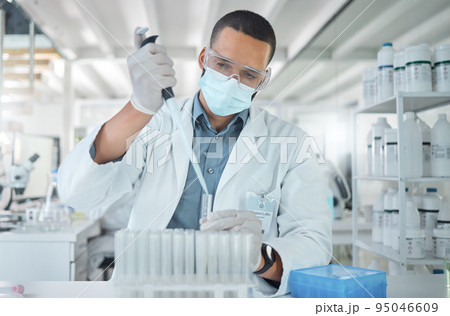 Covid, science and research with man in laboratory with a face mask working on medical, pharmacy and vaccine investigation. Innovation, healthcare and medicine with expert scientist and chemistry 95046609
