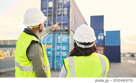 Industrial managers working on a warehouse dock to export stock, containers and packages. Teamwork, collaboration and logistics industry employees discussing shipping at an outdoor cargo freight port 95046979
