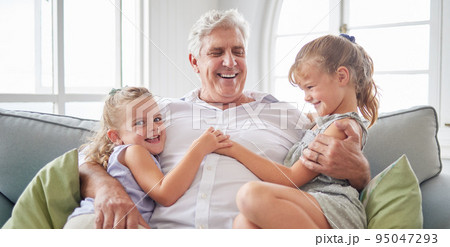 Happy family, retirement and old man playing with children on the sofa bonding, happiness and laughing together. Smile, elderly and grandpa with little girls enjoying quality time on a couch at home Happy family, retirement and old man playing with children on the sofa bonding, happiness and laughing together. Smile, elderly and grandpa with little girls enjoying quality time on a couch at home 95047293