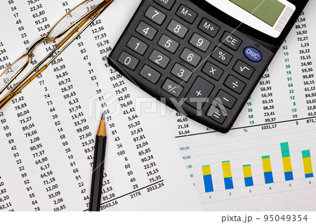 Top view office table desk. Financial report. Flat lay. Workspace with Business office supplies, Accounts number on the data paper, pencil, glasses, calculator on the table. Top view. Close-up Top view office table desk. Financial report. Flat lay. Workspace with Business office supplies, Accounts number on the data paper, pencil, glasses, calculator on the table. Top view. Close-up 95049354