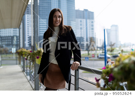 portrait of stylish modern woman in city cafe in early morning 95052624
