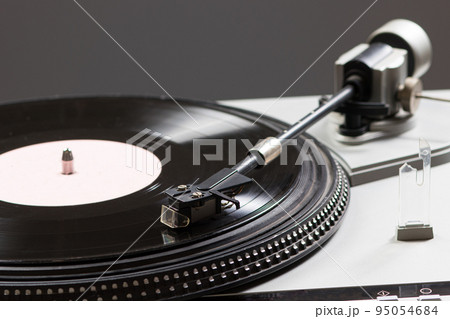 Vintage record player while recording, the record spins and music plays. Gramophone macro close-up photo. Vintage record player while recording, the record spins and music plays. Gramophone macro close-up photo. 95054684