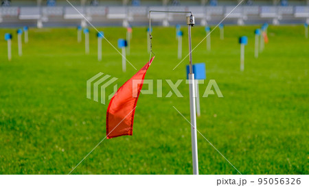 red wind direction flag biathlon shooting range. outdoor in the summer. red wind direction flag biathlon shooting range. outdoor in the summer. 95056326