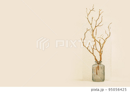 golden branches in a vase home decor. Fall autumn minimal background. Copy space golden foliage seasonal backdrop. happy thanksgiving or hello autumn golden branches in a vase home decor. Fall autumn minimal background. Copy space golden foliage seasonal backdrop. happy thanksgiving or hello autumn 95056425