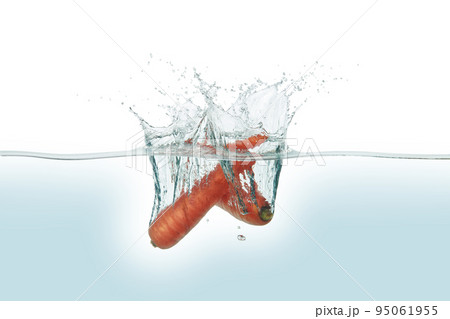 Two carrots splashing in water. 95061955