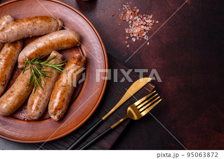 Roasted sausages grill with spices and herbs with salt and pepper Roasted sausages grill with spices and herbs with salt and pepper 95063872