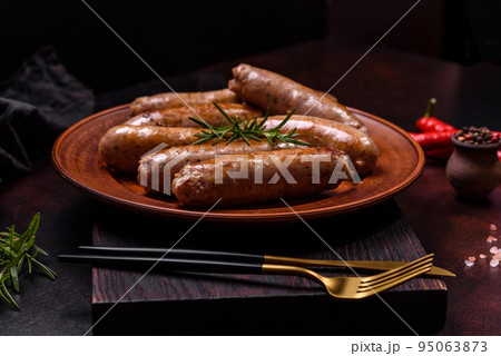 Roasted sausages grill with spices and herbs with salt and pepper Roasted sausages grill with spices and herbs with salt and pepper 95063873