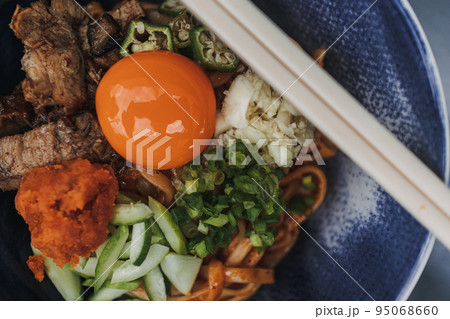 Hongkong style noodle with fresh raw egg and some vegetables. Hongkong style noodle with fresh raw egg and some vegetables. 95068660