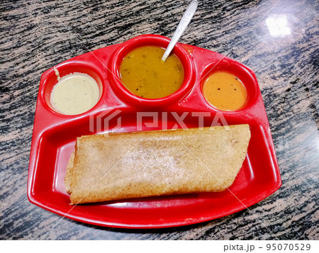 Masala dosa is a South Indian meal served with sambhar and coconut chutney. Selective focus Masala dosa is a South Indian meal served with sambhar and coconut chutney. Selective focus 95070529