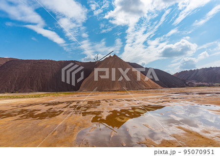 Mining industry close up. Telestacker handles the ore closeup for potash waste heaps, extraction of salt and potash fertilizers in a quarry and processing of ore 95070951