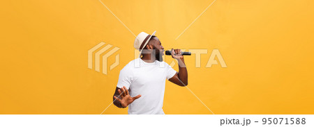 Young teenage black African American boy singer performing at a concert. 95071588