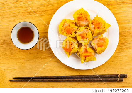 Top view, flat lay fresh delicious homemade shrimp, minced pork and salted egg yolk steamed dumplings. 95072009