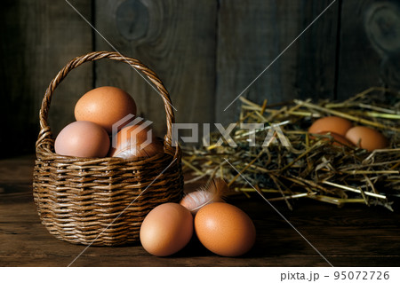 chicken eggs in wicker basket and in nest chicken eggs in wicker basket and in nest 95072726
