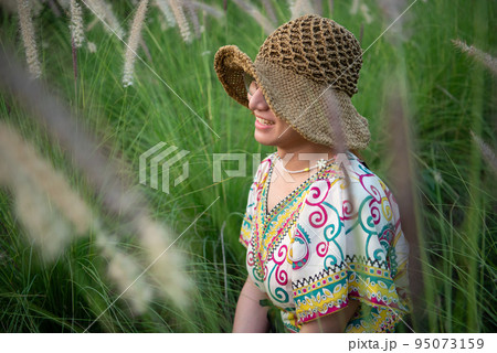 Woman (LGBTQ) posing at flower park garden field 95073159