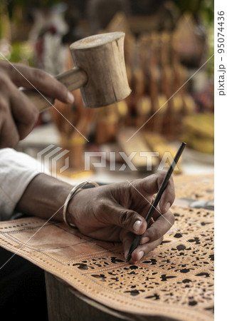 craft artist making traditional buffalo leather carving art in indonesia craft artist making traditional buffalo leather carving art in indonesia 95074436